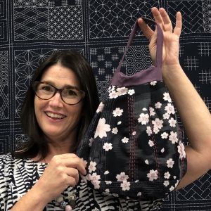 Teacher Sharon Thomson with a stitched version of the Raindrop bag.